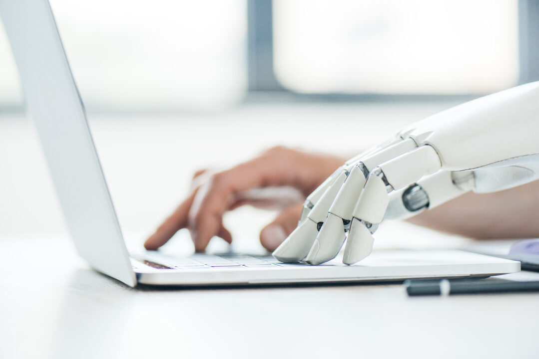 selective focus of human and robot hands typing on 2023 11 27 05 28 22 utc